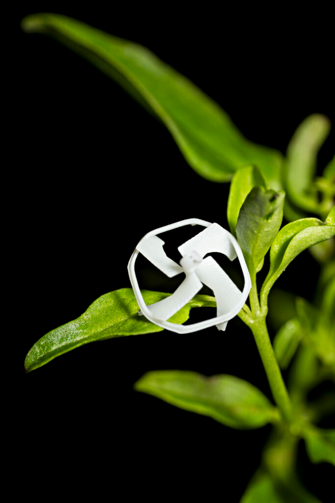 The miniature flying robot resting on a green plant leaf, from Berkeley News.
